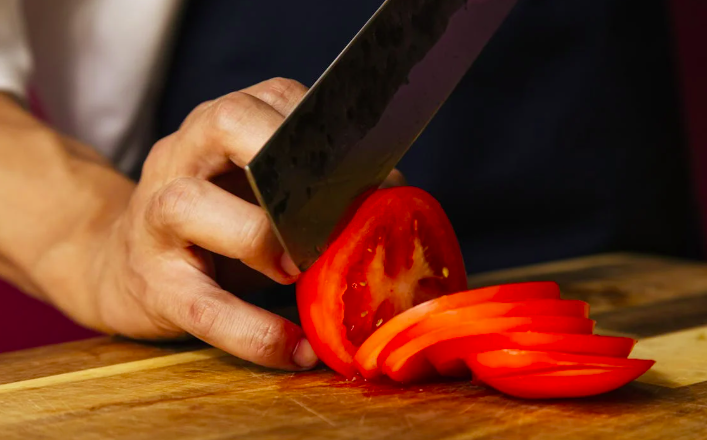 Chop tomatoes with a sharp knife